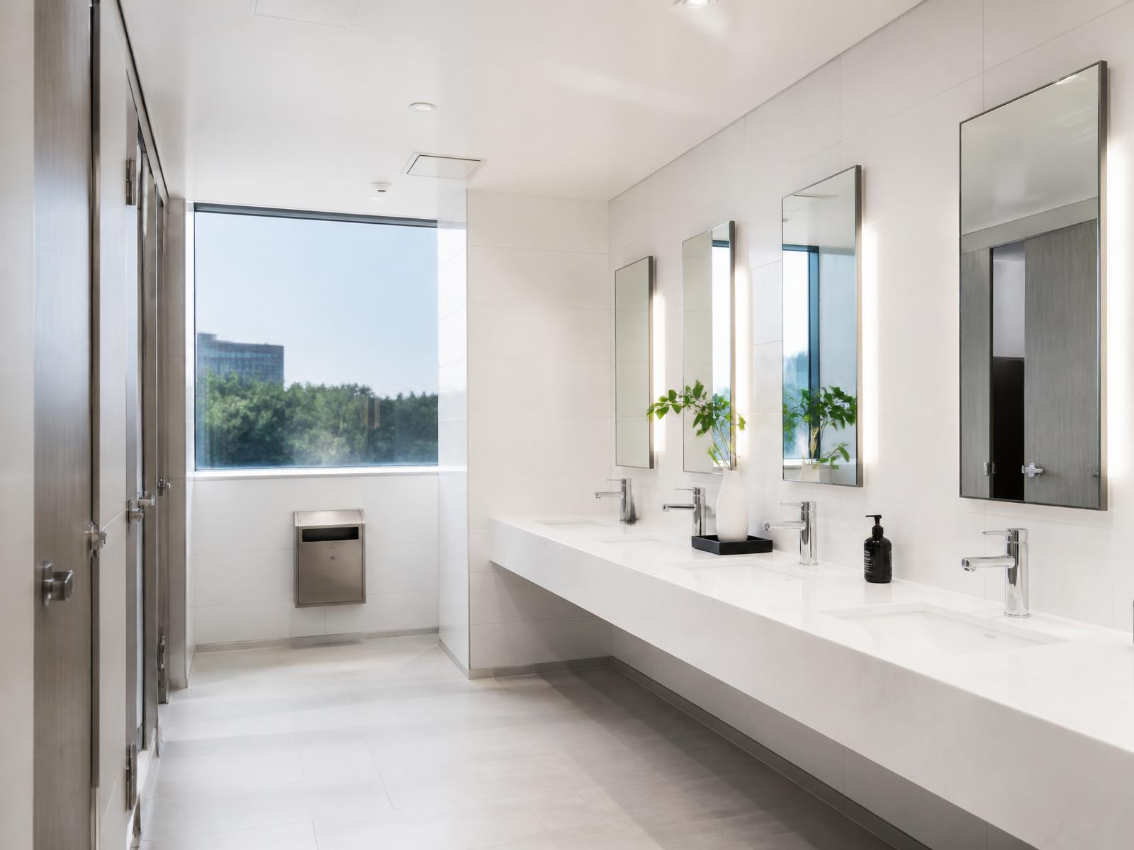 Bright, spotless commercial restroom with clean sinks and mirrors